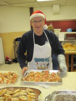 Volunteer Jim Comeau serving up dinner