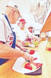 Volunteers Jim Comeau, left, Paul Windt and Bonnie Rankin, all of Chelmsford, prepare for a pizza dinner at Table of Plenty at First Parish Unitarian Universalist Church in Chelmsford.